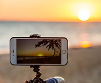Phone on tripod taking picture of beautiful sunset